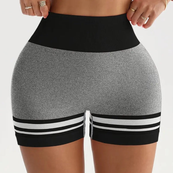 Black and gray athletic shorts with white stripes on a plain background