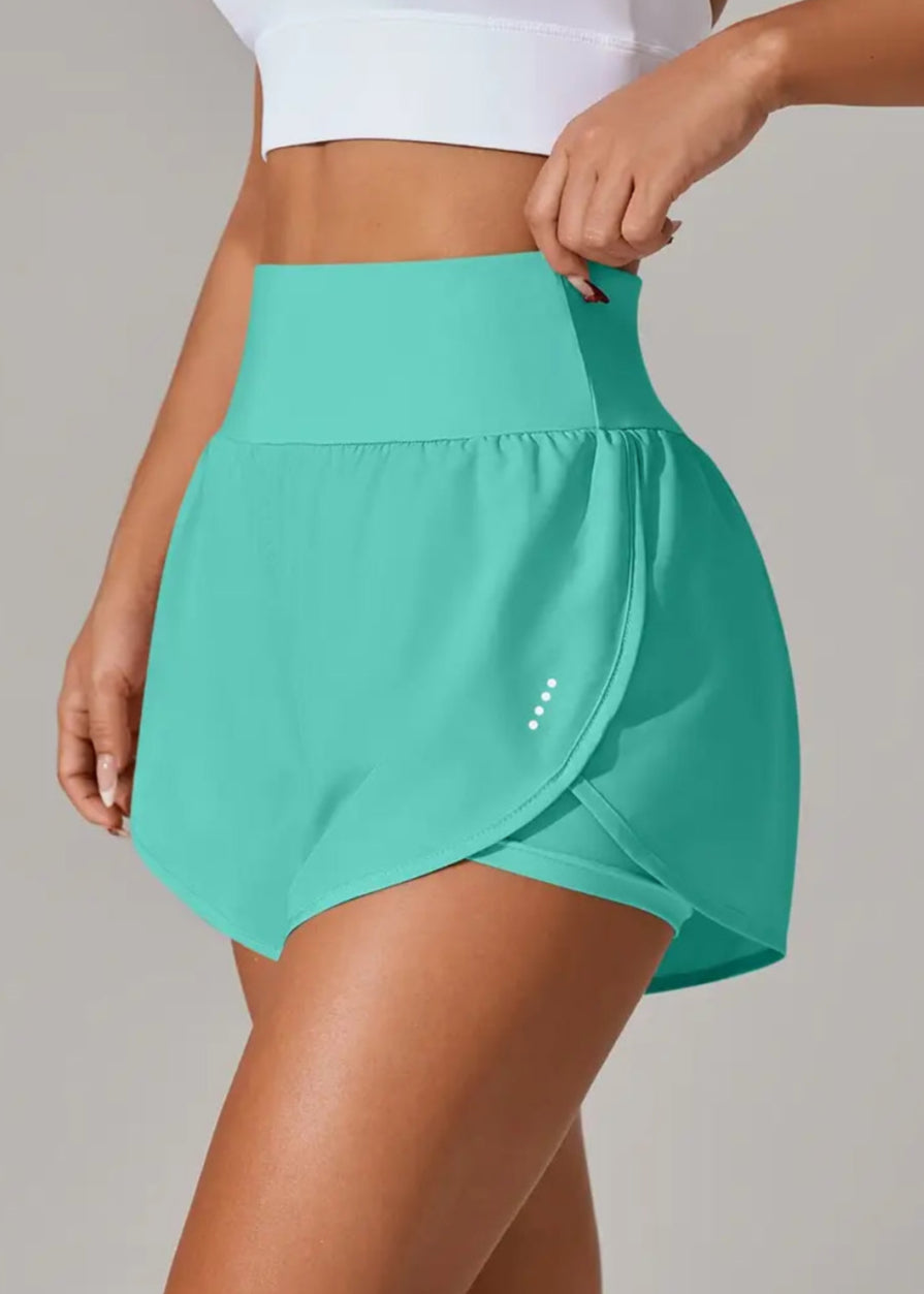 Teal athletic skirt worn by a person on a plain background