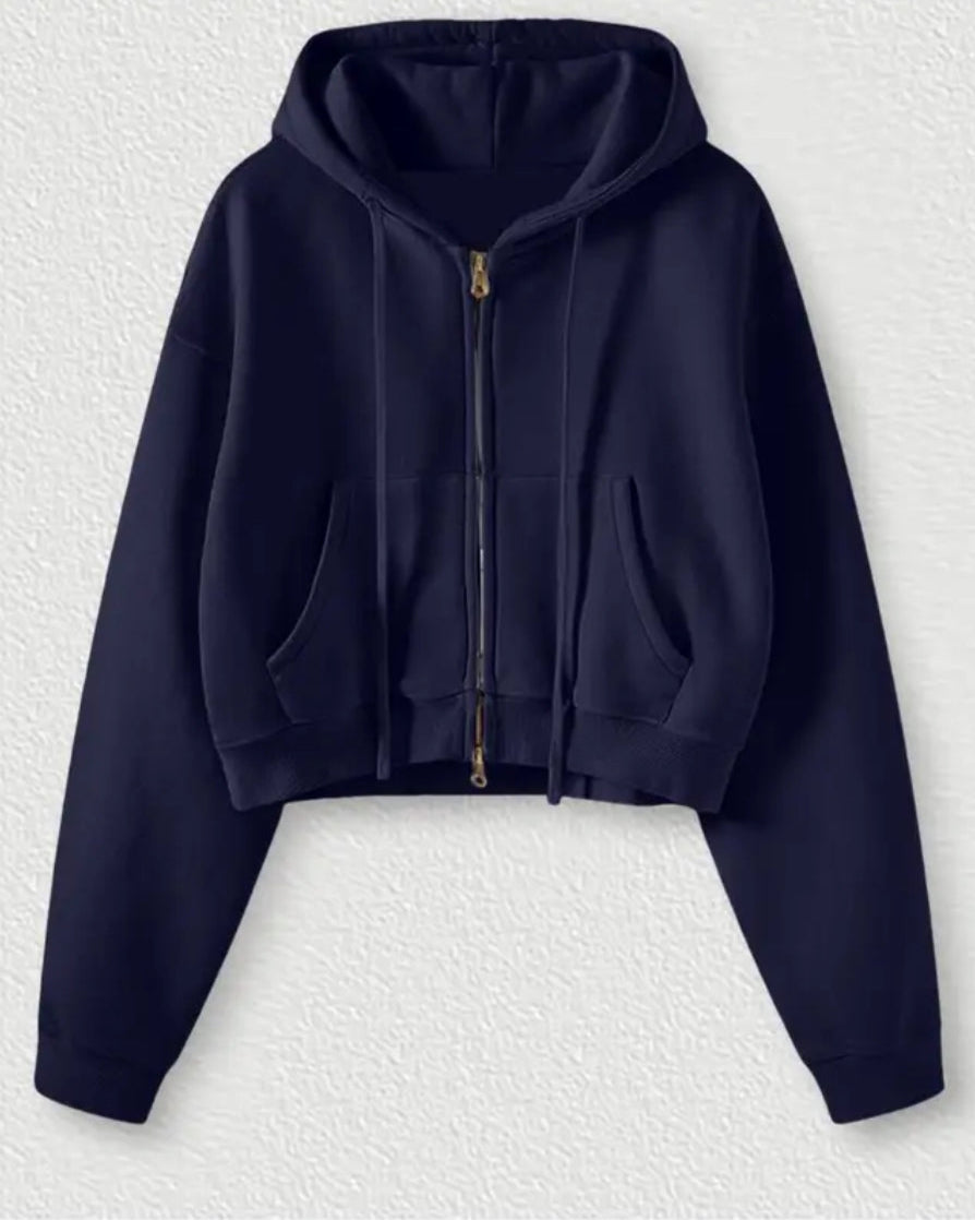 Navy blue hoodie on a textured white background