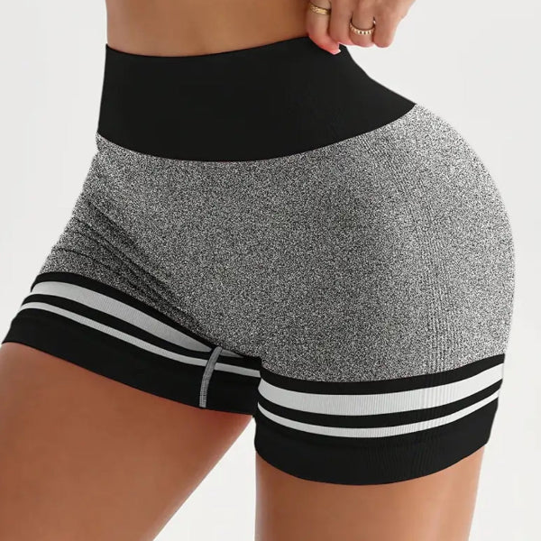 Person wearing black and gray athletic shorts with white stripes on a white background