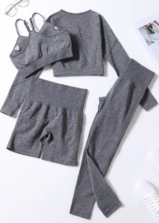 Gray athletic wear set including a long-sleeve top, shorts, and leggings on a white background.