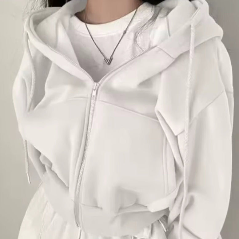 White hoodie worn by a person on a plain background