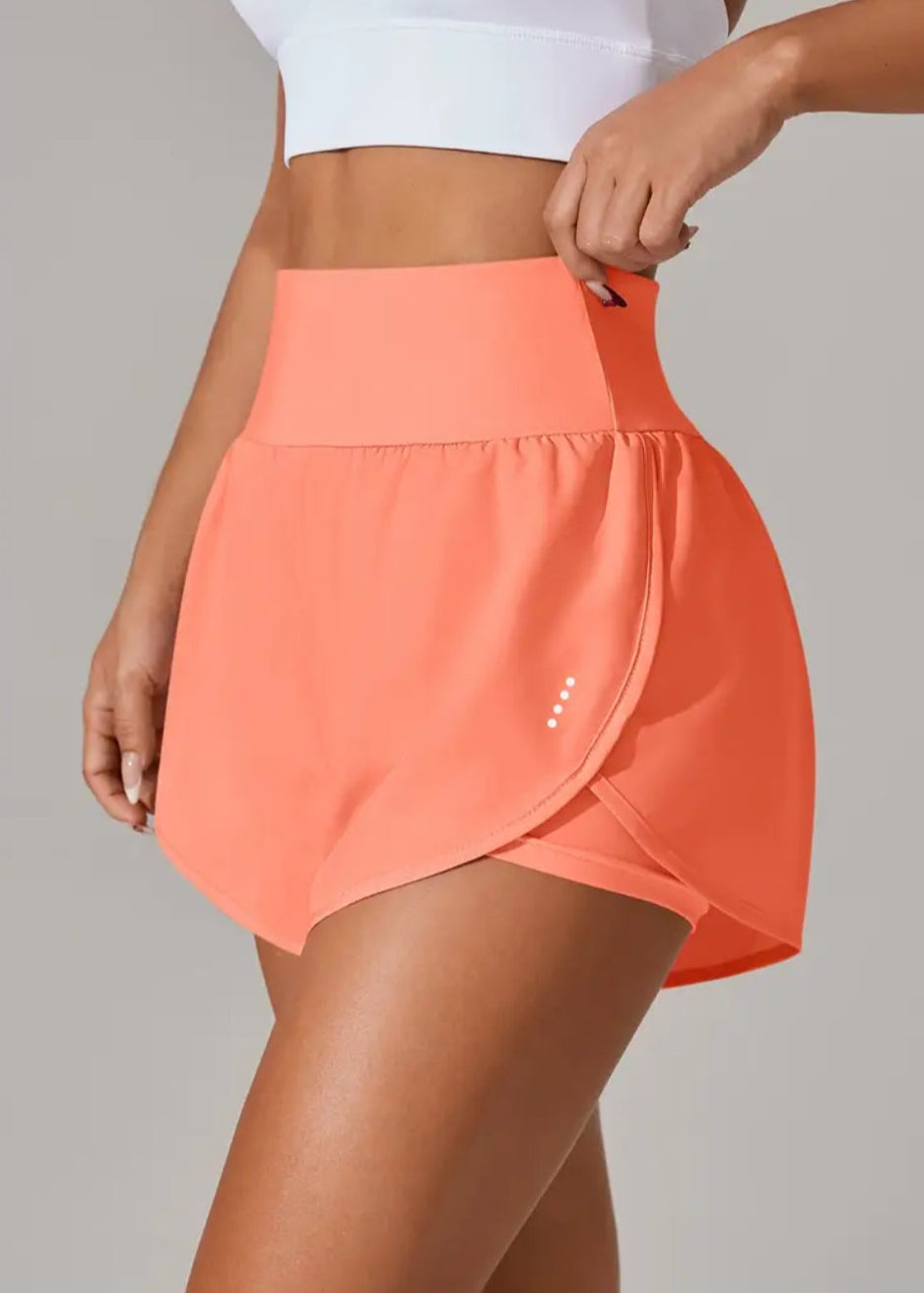 Person wearing a coral skirt on a plain background