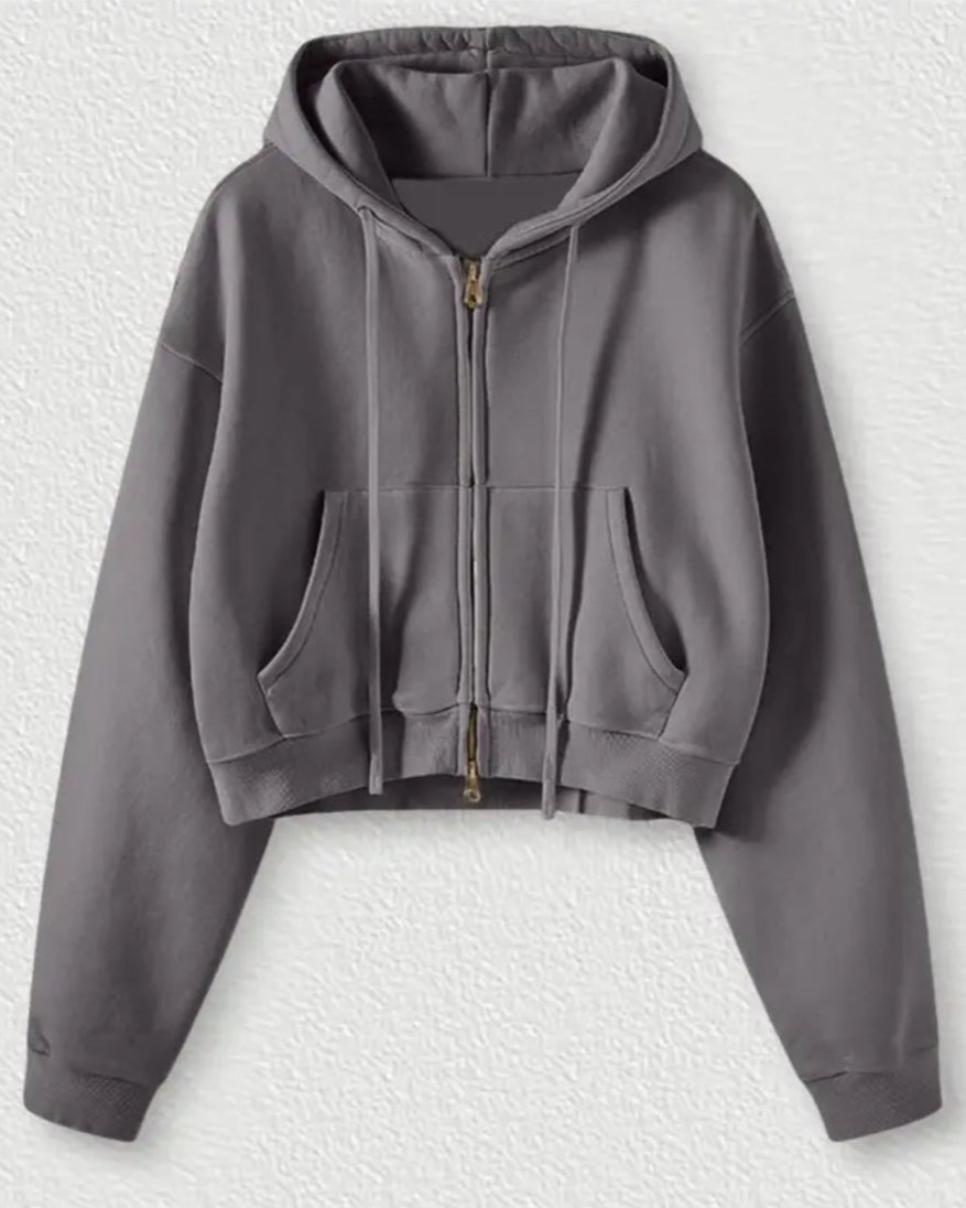 Gray hoodie with a zipper on a textured white background