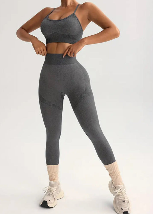 Person wearing a gray athletic outfit on a light gray background