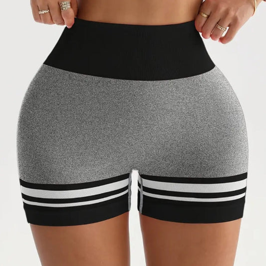 Black and gray athletic shorts with white stripes on a plain background