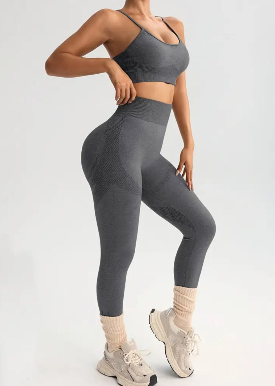 Person wearing a gray athletic outfit on a white background