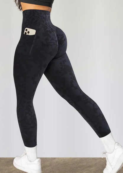 Black leggings worn by a person on a plain background