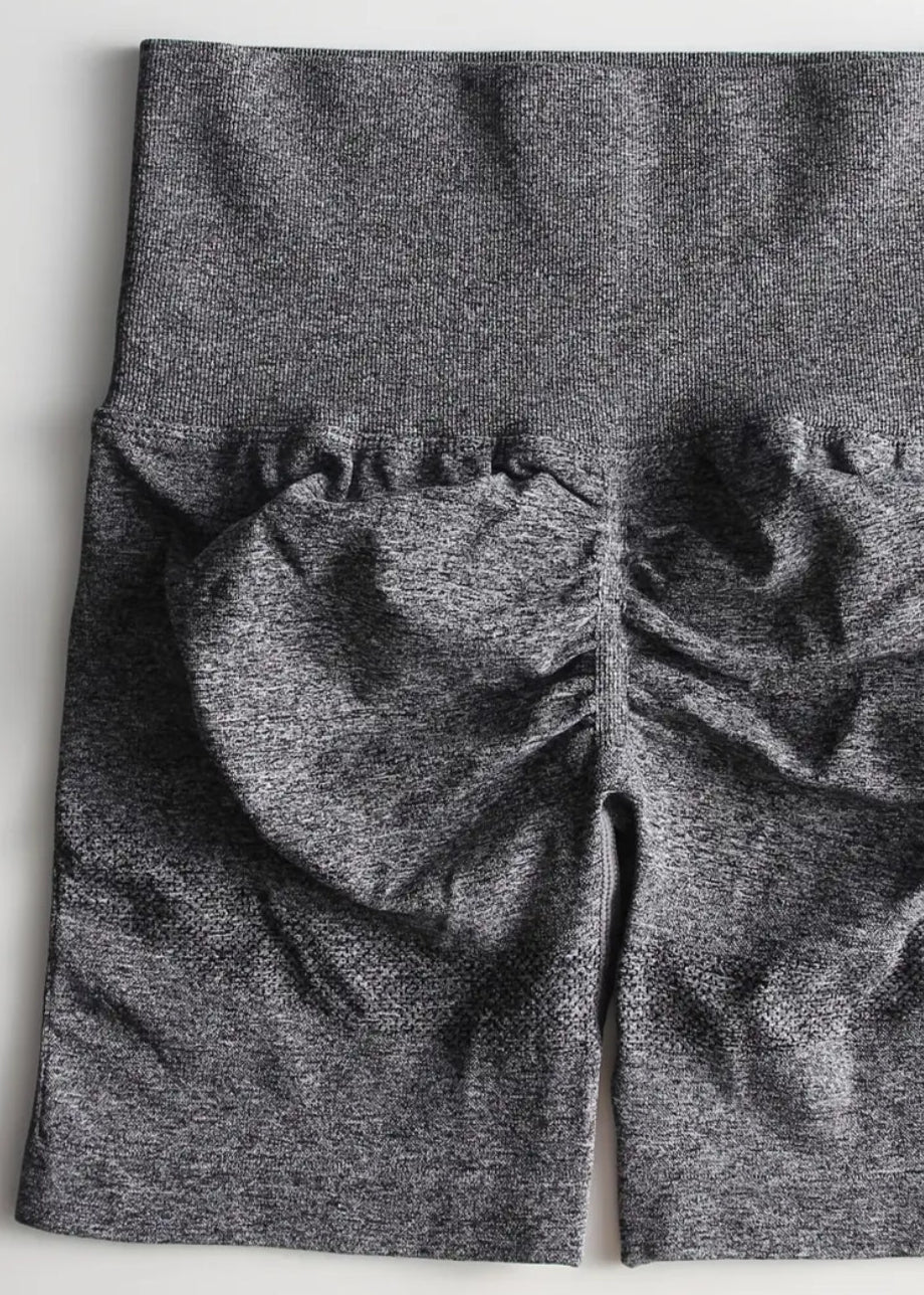 Gray leggings with a textured pattern on a white background
