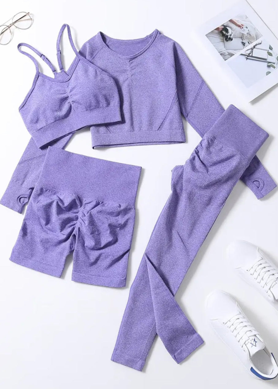 Purple clothing set with top, shorts, and leggings on a white background