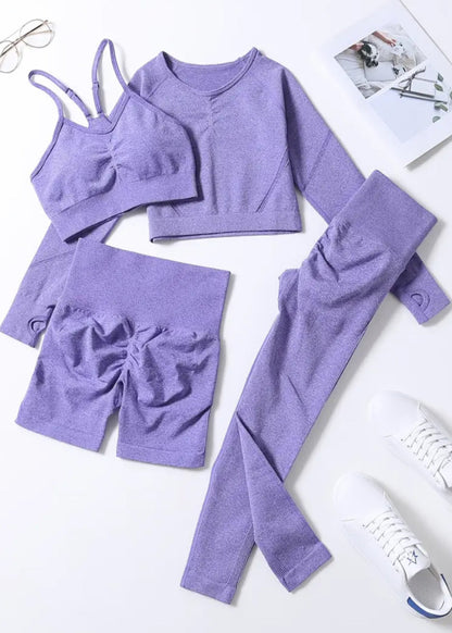 Purple clothing set with top, shorts, and leggings on a white background