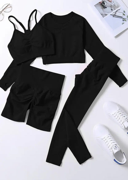 Black outfit with top, pants, and shoes on a white background