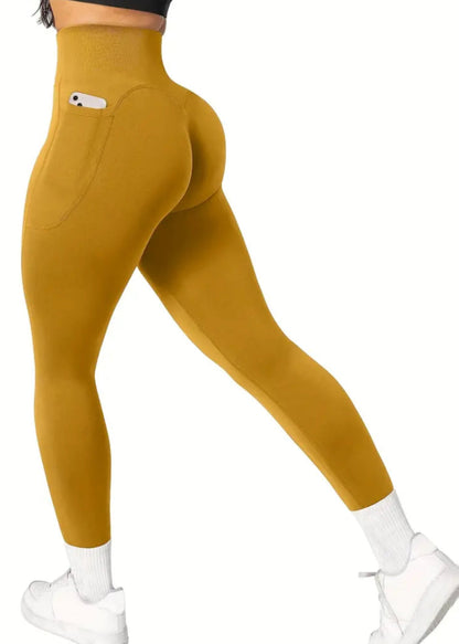 Mustard yellow leggings worn by a person on a white background