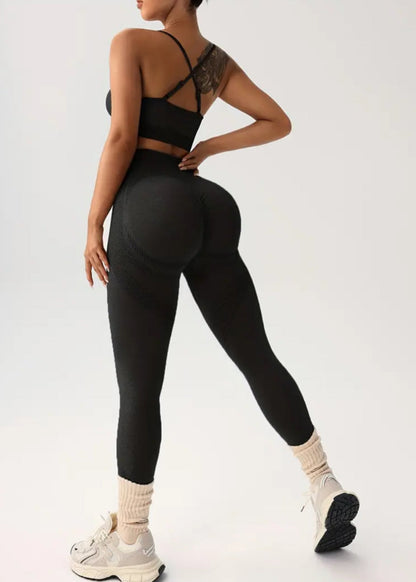 Person wearing a black athletic outfit on a white background