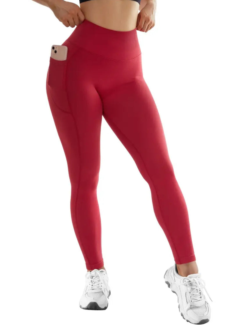 Red leggings worn by a person on a white background