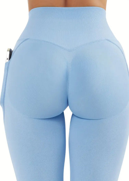 Light blue leggings with a high waist and side pockets on a white background