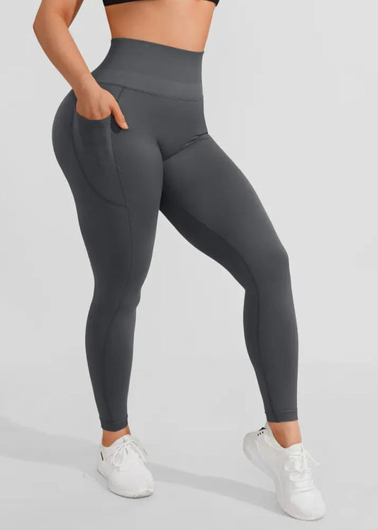 Person wearing gray leggings on a light gray background
