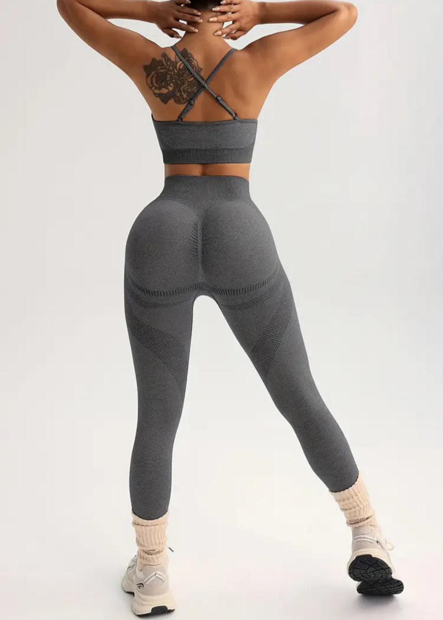Person wearing a gray athletic outfit on a white background