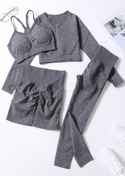 Gray athletic wear set including a sports bra, leggings, and shorts on a white background.