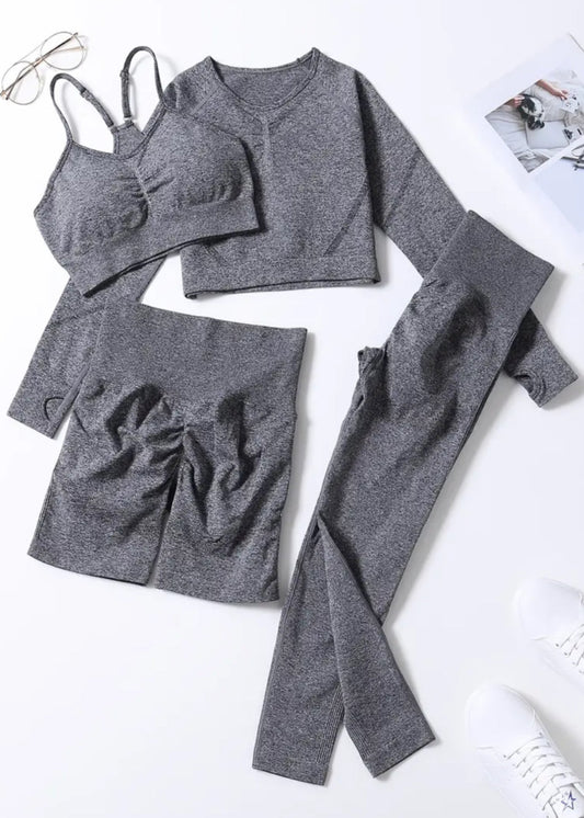 Gray athletic wear set including a sports bra, leggings, and shorts on a white background.