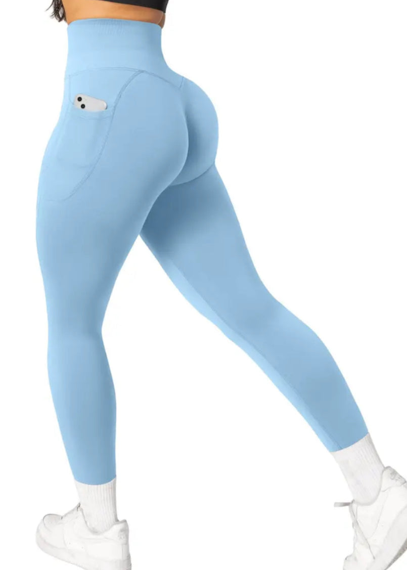 Light blue leggings worn by a person on a white background