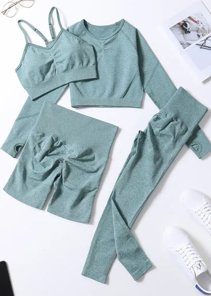 Teal loungewear set with long-sleeve top, shorts, and leggings on a white background.
