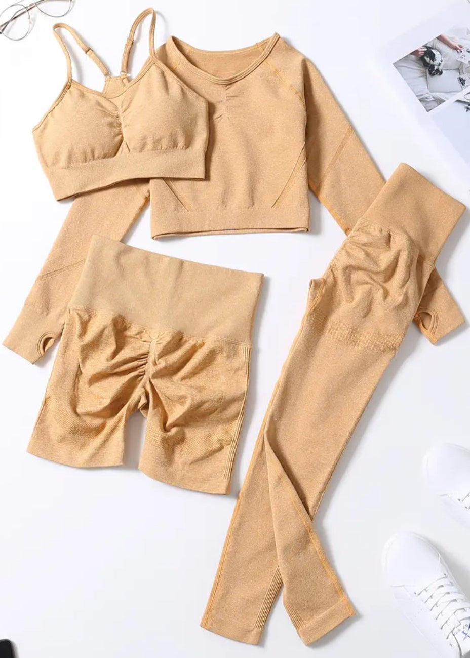Beige clothing set including a top, shorts, and pants on a white background