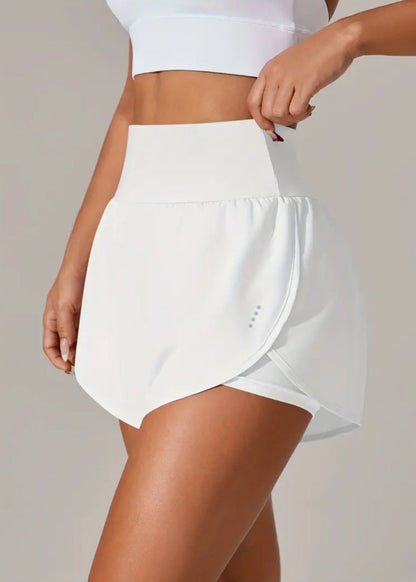 White athletic skirt worn by a person on a plain background