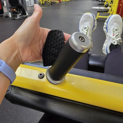 Person using a gym machine with a close-up of the workout hand grip  