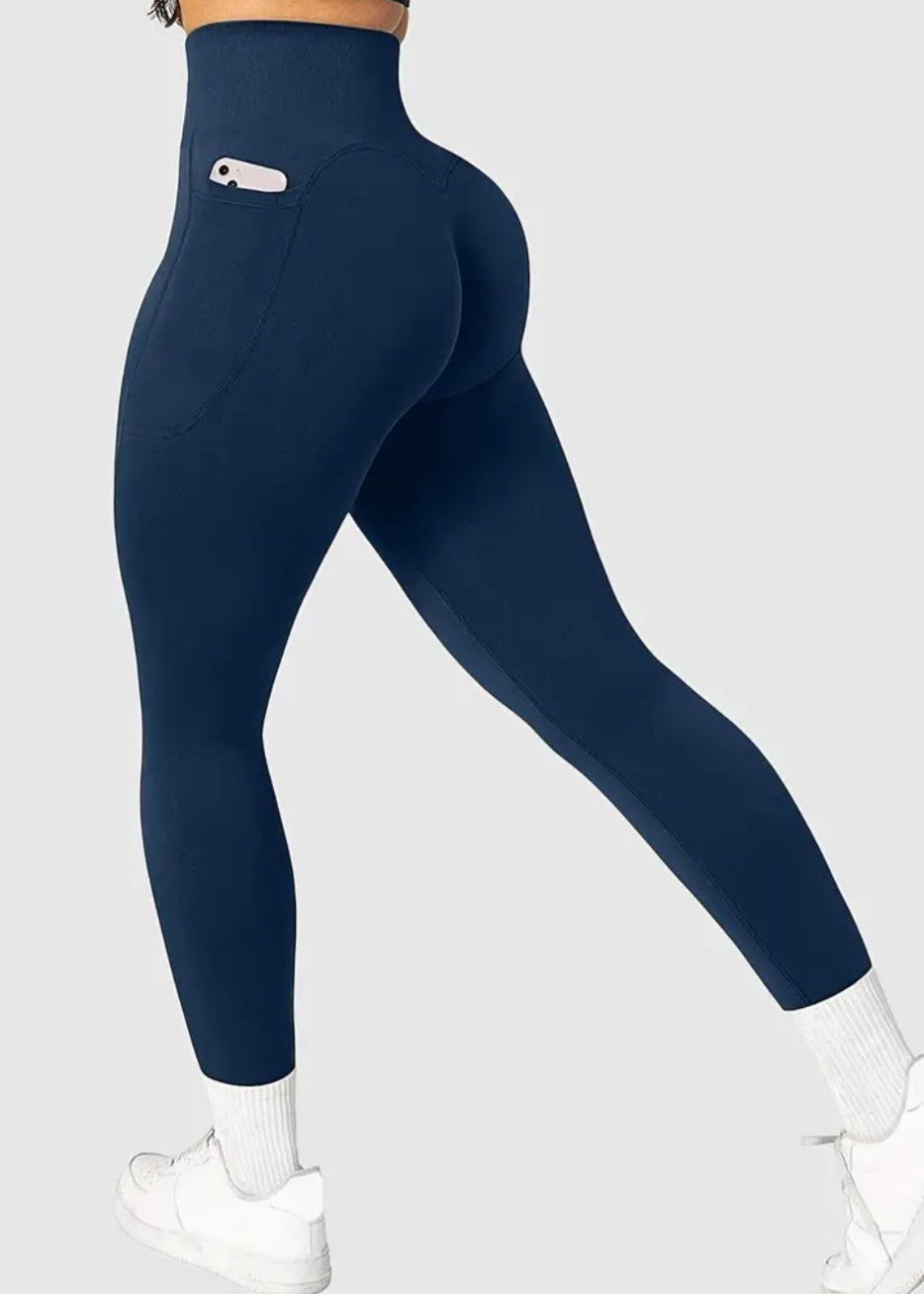 Navy blue leggings worn by a person on a light gray background
