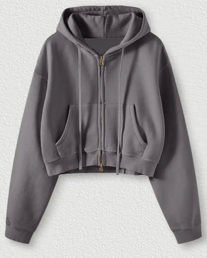 Gray hoodie with a zipper on a textured white background